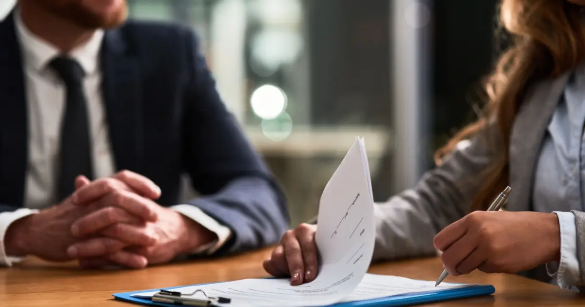 Person reviewing and signing insurance documents